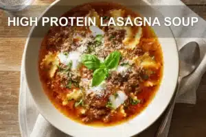 High Protein Lasagna Soup: Easy Cozy Comfort Food HIGH PROTEIN LASAGNA SOUP overhead bowl with reginetti, warm broth, pressed tomatoes, grated cheese