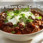 Hairy Bikers Chilli Con Carne hearty bowl on white napkin with glass of water