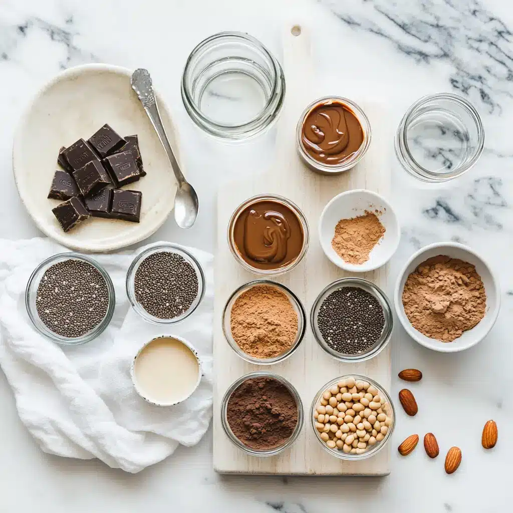 High-Protein, Chocolate Peanut Butter Chia Pudding: Simple Delicious Recipe 4 Ingredients for high protein chocolate peanut butter chia pudding including chia seeds, cocoa powder, peanut butter, and almond milk displayed artfully