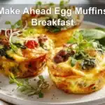 Make Ahead Egg Muffins Breakfast three golden muffins with melty cheese peppers spinach bacon and sausage