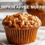 PUMPKIN APPLE MUFFINS hero shot three quarter angle warm tones on white cloth
