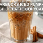 STARBUCKS ICED PUMPKIN SPICE LATTE COPYCAT glass with whipped topping cinnamon and caramel drizzle