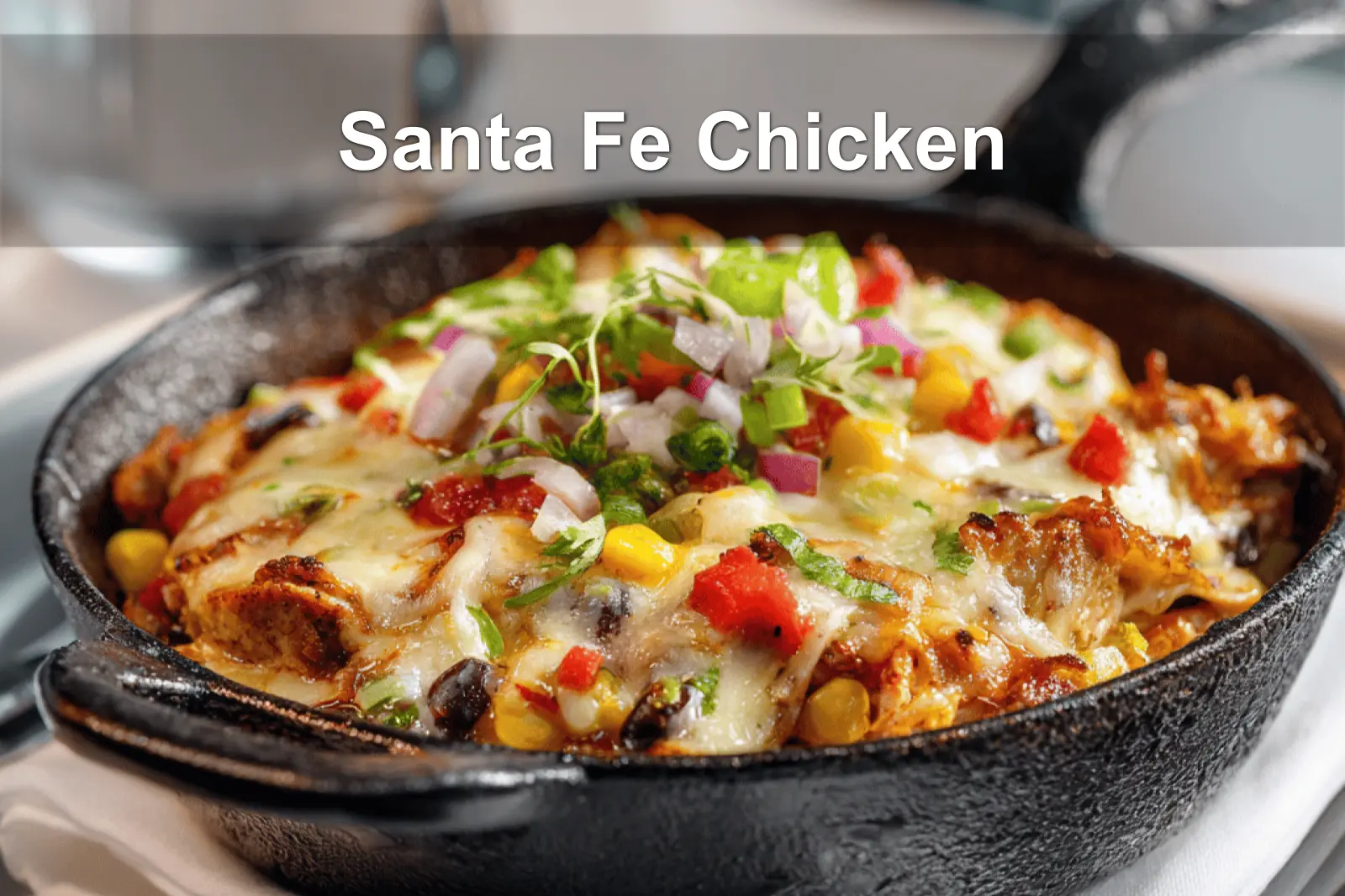 Santa Fe Chicken skillet with black beans corn melted cheese and fresh herbs in warm light