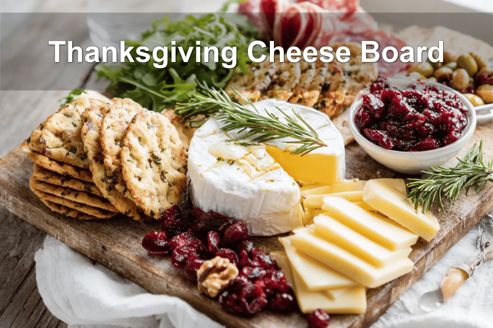 Thanksgiving Cheese Board with brie manchego white cheddar cranberry goat cheese assorted salami