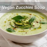 Vegan Zucchini Soup Simple Cozy Recipe You'll Love 6 Vegan Zucchini Soup in white bowl with basil garnish olive oil drizzle cozy natural lighting