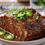 Mississippi Pot Roast: Irresistible and Simple Recipe 6 mississippi pot roast on white napkin with buttery glaze and clear glass of water
