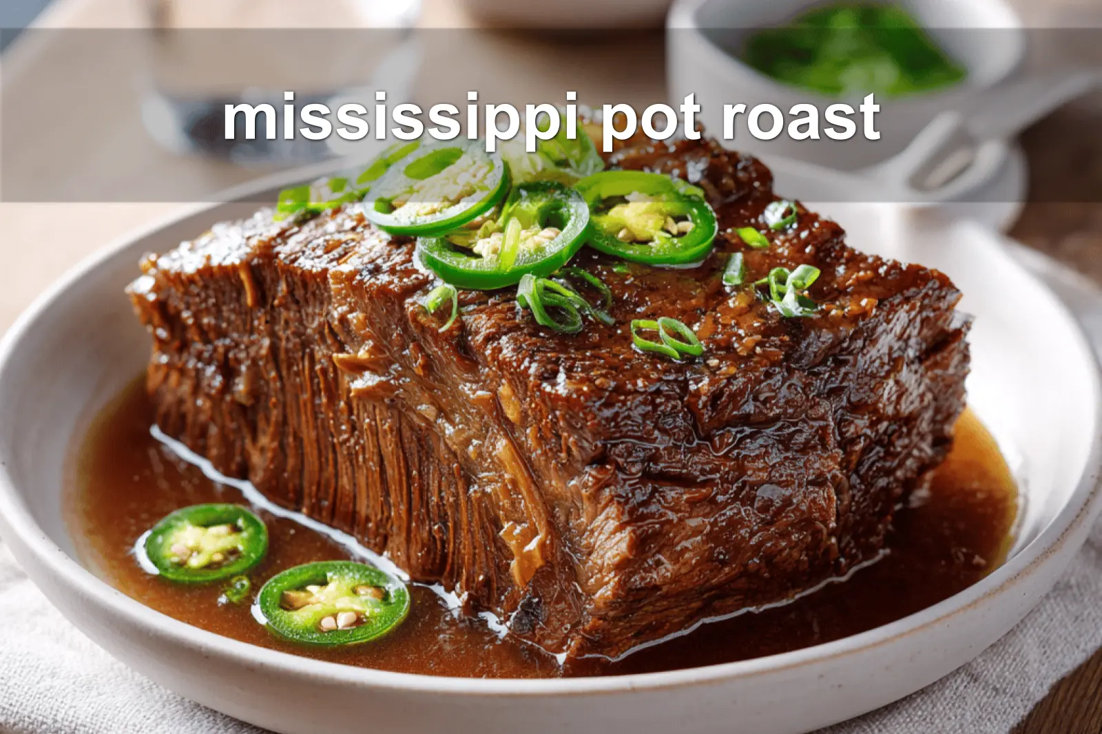 mississippi pot roast on white napkin with buttery glaze and clear glass of water