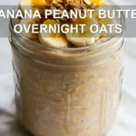 BANANA PEANUT BUTTER OVERNIGHT OATS jar with banana and peanut butter warm natural light