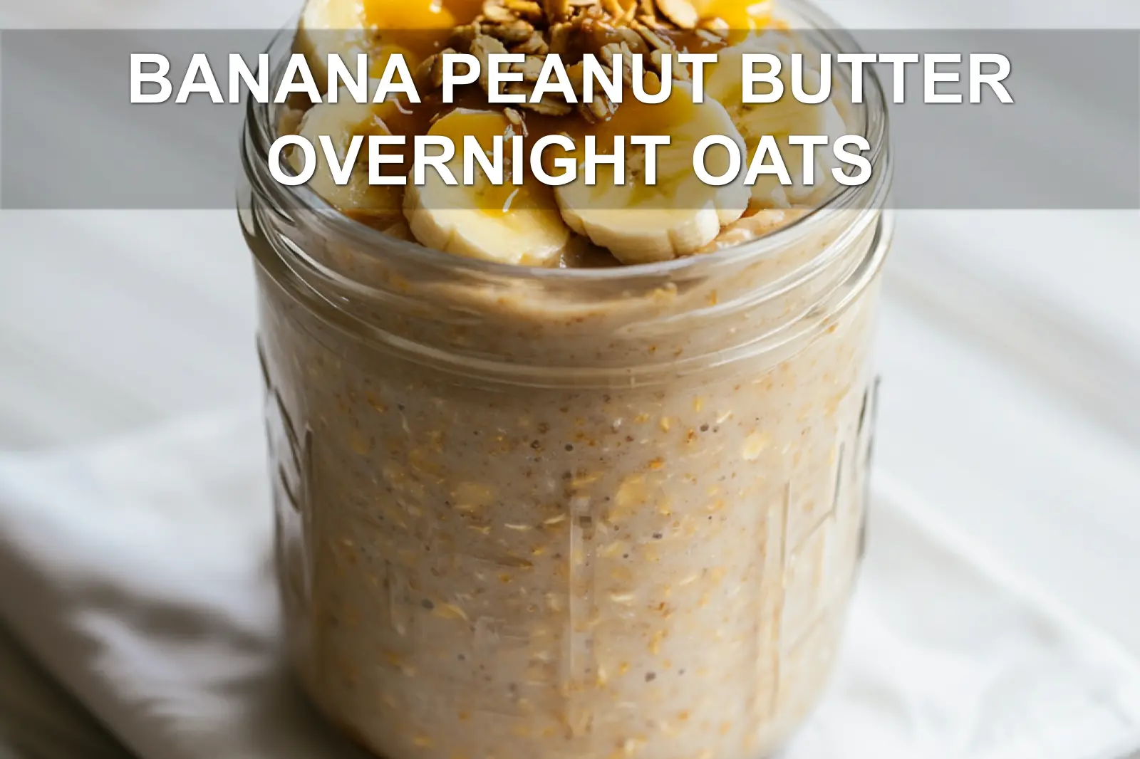 BANANA PEANUT BUTTER OVERNIGHT OATS jar with banana and peanut butter warm natural light