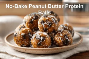NO BAKE PEANUT BUTTER PROTEIN BALLS on white cloth with clear glass of water, warm styling
