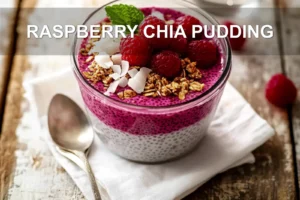 RASPBERRY CHIA PUDDING topped with raspberries sliced almonds coconut flakes maple syrup and mint