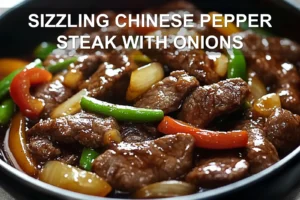 SIZZLING CHINESE PEPPER STEAK WITH ONIONS served with steamed rice green onions vibrant peppers