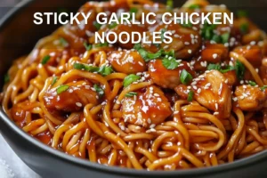 STICKY GARLIC CHICKEN NOODLES glazed chicken and noodles in warm bowl with green onions