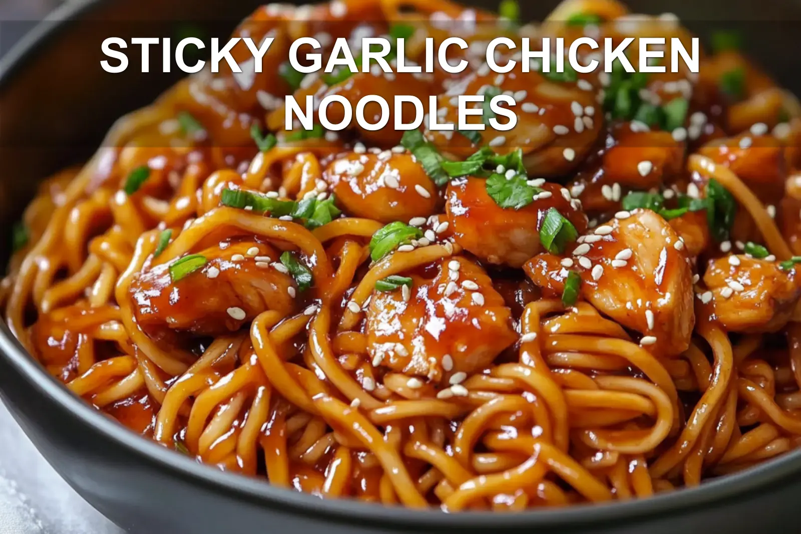 STICKY GARLIC CHICKEN NOODLES glazed chicken and noodles in warm bowl with green onions