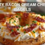 ZESTY BACON CREAM CHEESE BAGELS close-up with sesame bagel bacon cheddar creamy sauce fresh chives