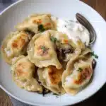 POLISH SAUERKRAUT AND MUSHROOM PIEROGI centered hero view, clean and uncluttered