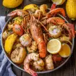 CAJUN SEAFOOD BOIL WITH GARLIC BUTTER SAUCE centered hero view, clean and uncluttered