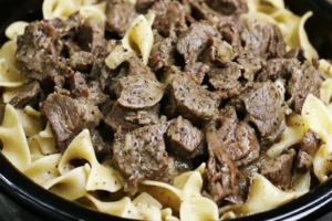 Crock Pot Beef and Noodles Easy Comforting Dinner CROCK POT BEEF AND NOODLES centered hero view, clean and uncluttered