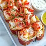 BEST EVER WARM BUTTERY LOBSTER ROLLS centered hero view, clean and uncluttered