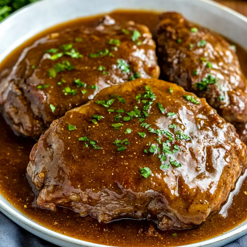 Slow Cooker Salisbury Steak Easy Comforting Dinner 6 Slow Cooker Salisbury Steak with rich gravy on a white plate
